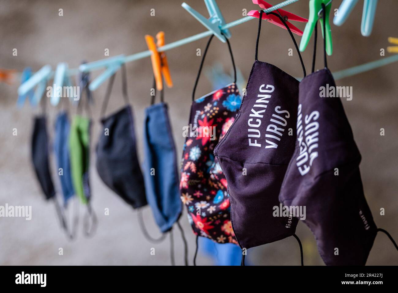 laundry of anti-virus masks hanging in a dryer. Stock Photo