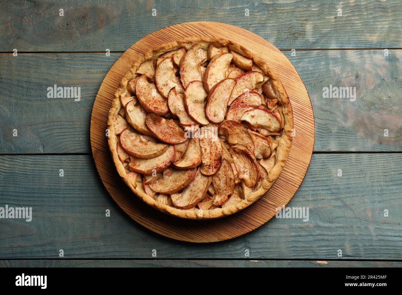 Delicious apple pie on light blue wooden table, top view Stock Photo