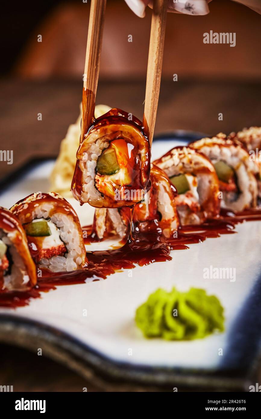 https://c8.alamy.com/comp/2R426T6/roll-made-of-fresh-raw-salmon-smoked-eel-cream-cheese-and-avocado-inside-topped-with-smoked-eel-unagi-2R426T6.jpg