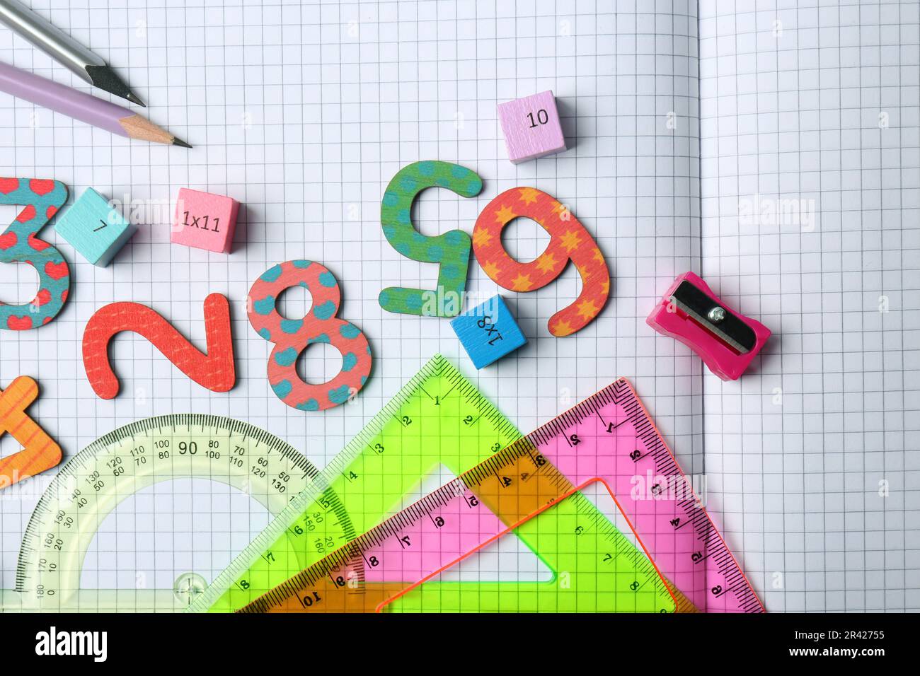 Flat lay composition with colorful numbers on notebook with grid pages ...