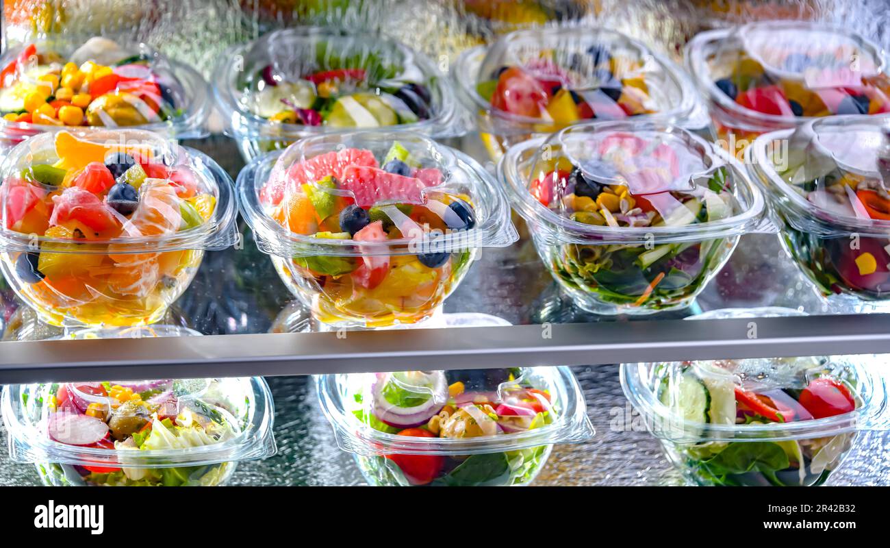 Plastic boxes with prepackaged fruit and vegetable salads Stock Photo