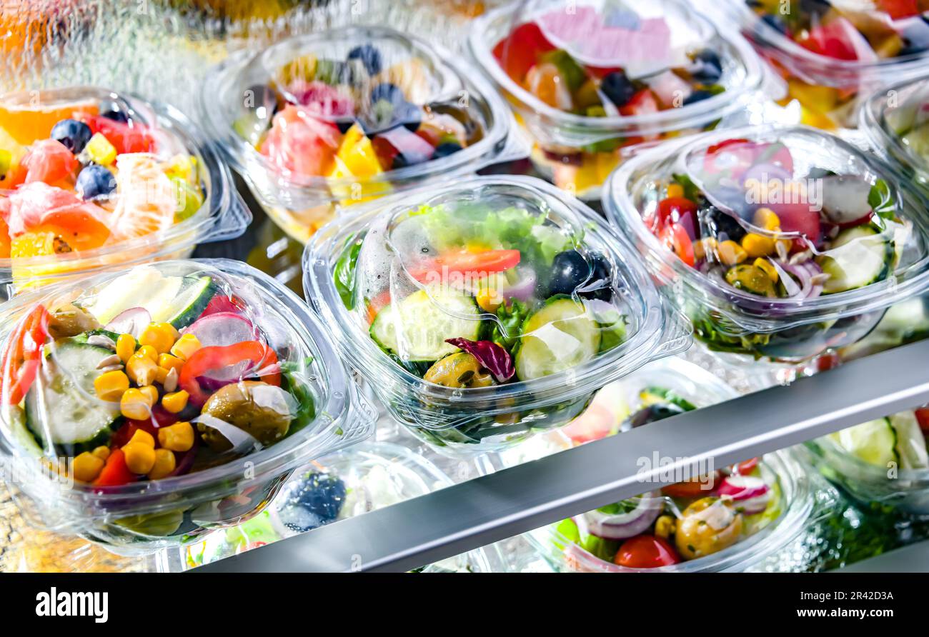 Plastic boxes with prepackaged fruit and vegetable salads Stock Photo
