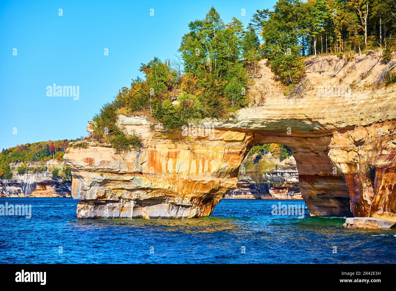Sapphire waters in Lake Michigan with cliff archway at Pictured Rocks