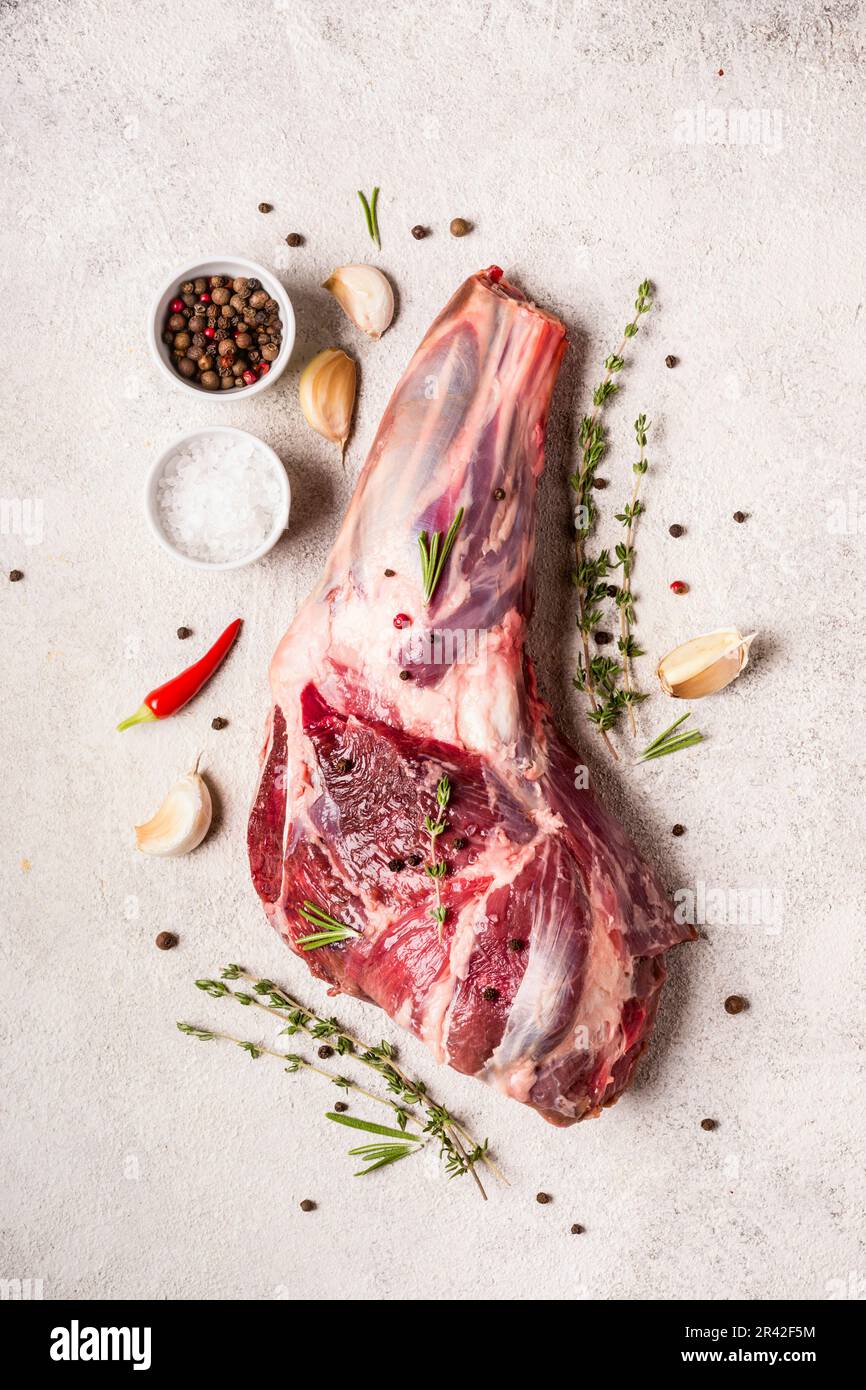 Raw fresh Lamb Meat shank and seasonings on gray concrete background Stock Photo