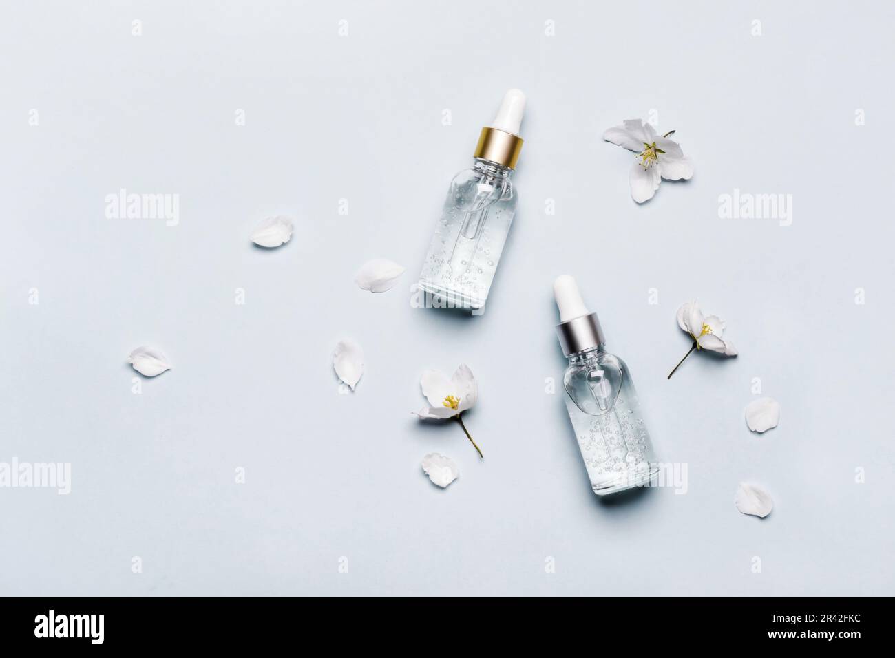 Serum or Liquid Collagen Bottles on pastel blue background. Anti age Cosmetics products concept Stock Photo