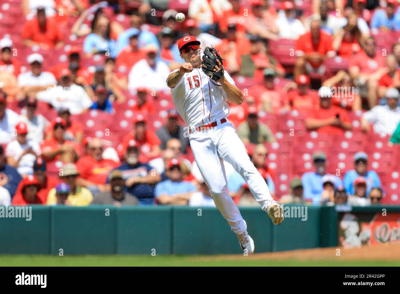 Cincinnati Reds' Nick Senzel fields the ball and throws to first base