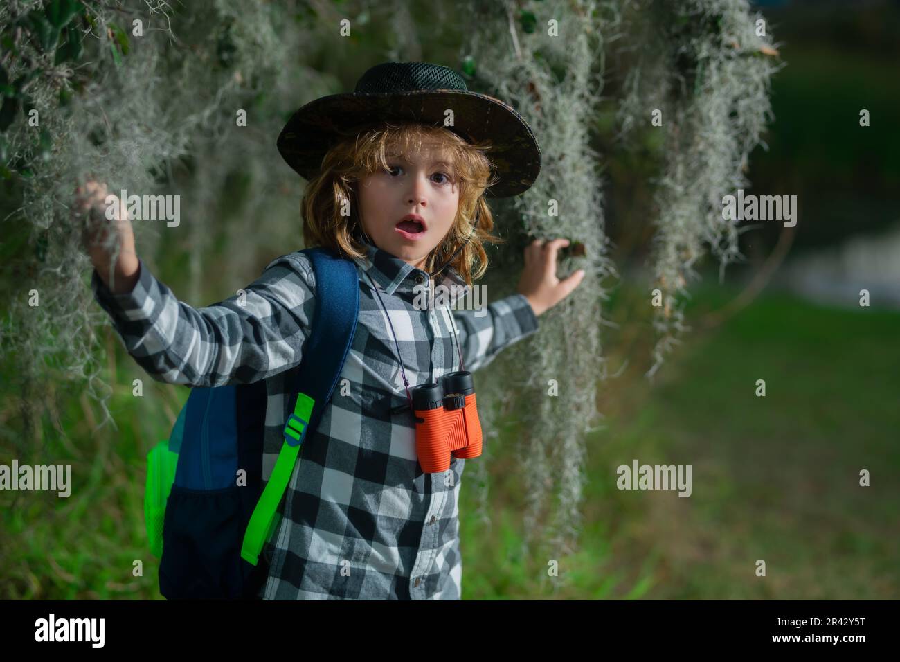 Happy child playing with binoculars. Explore and adventure. Child boy ...