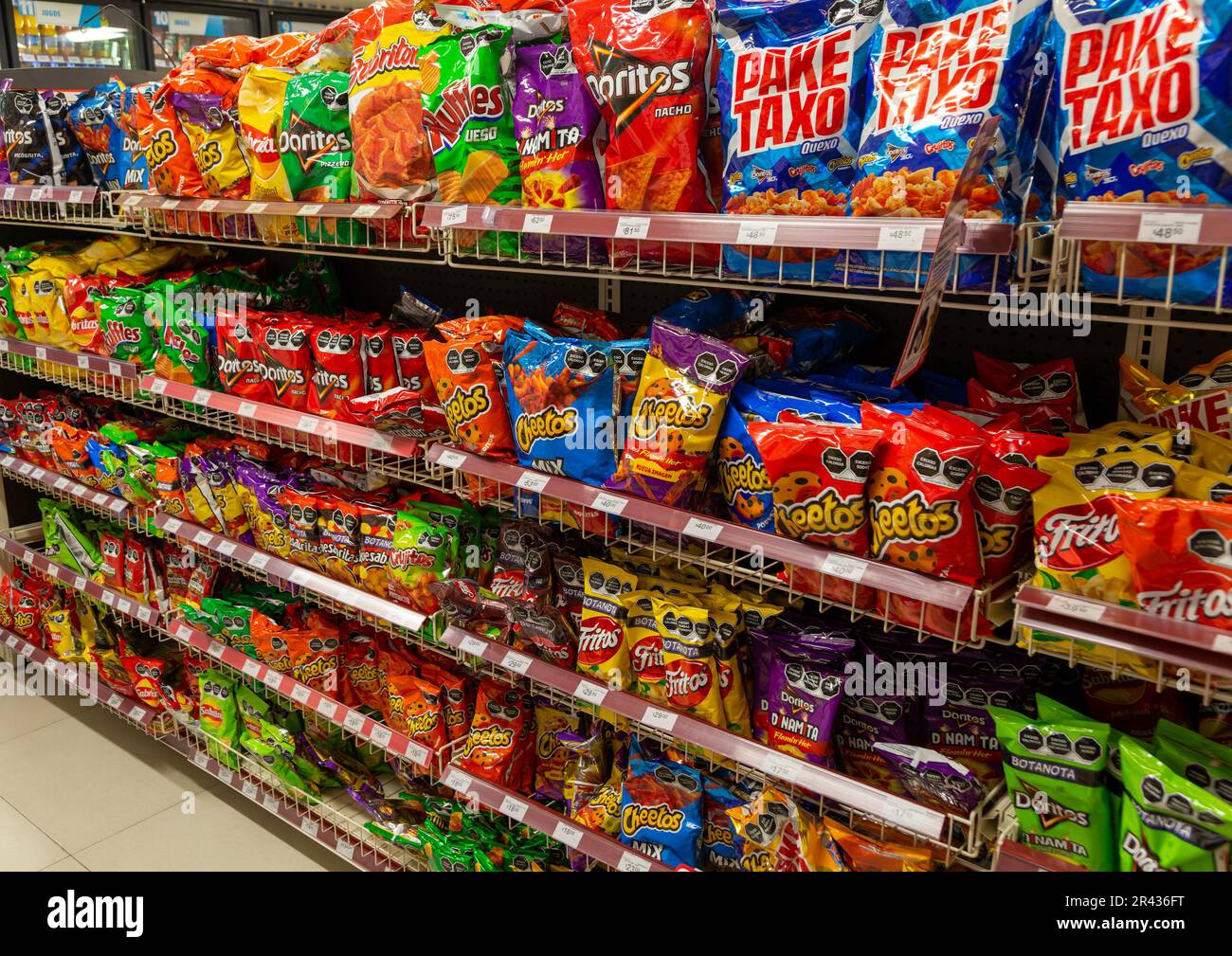 Display rows of packets of crips, bags of chips, potato and corn snacks