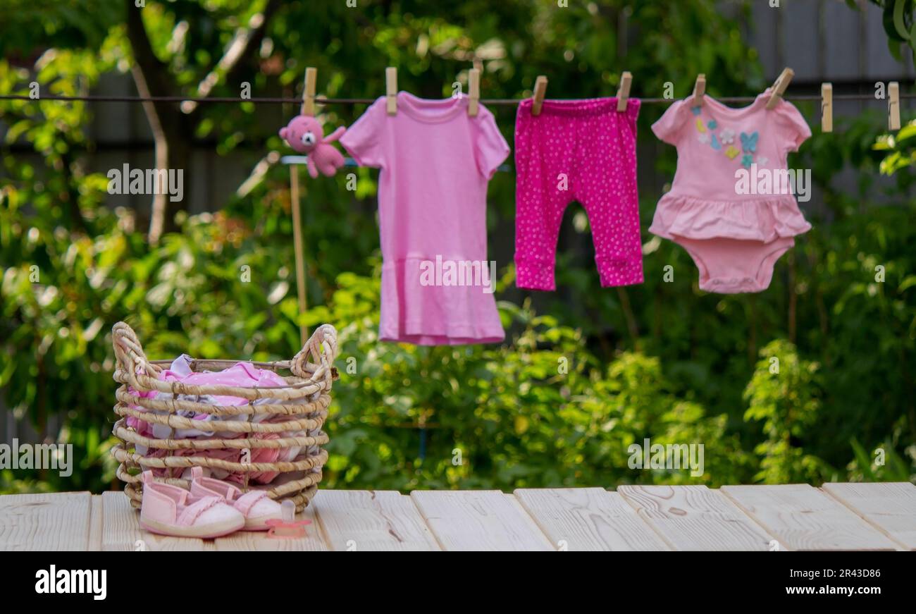 washing baby clothes. Linen dries in the fresh air. Selective focus. nature. Stock Photo