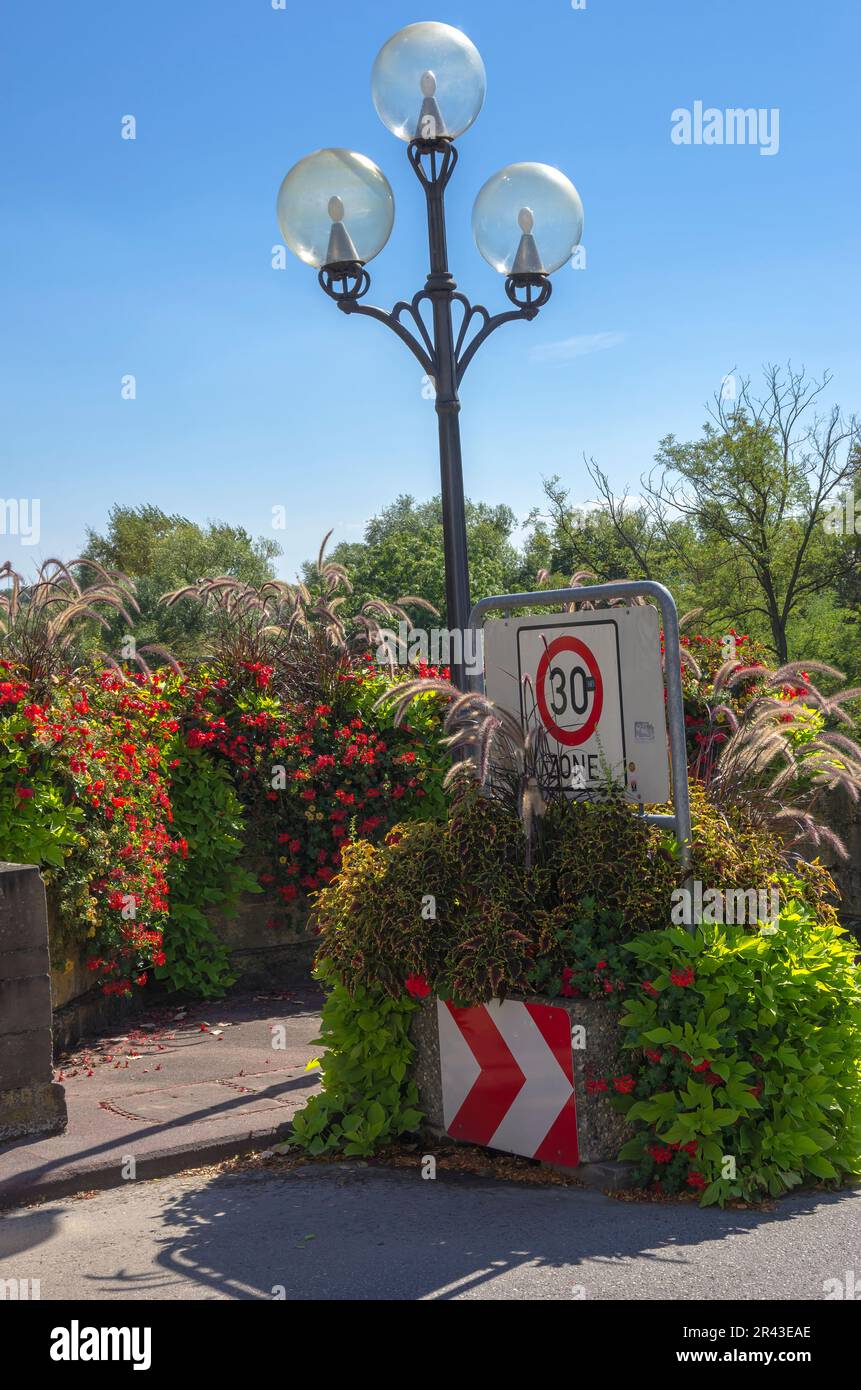 Street light and restricted to 30 km/h zone on the Neckar bridge in the Old Town of Lauffen am Neckar, Baden-Wurttemberg, Germany. Stock Photo