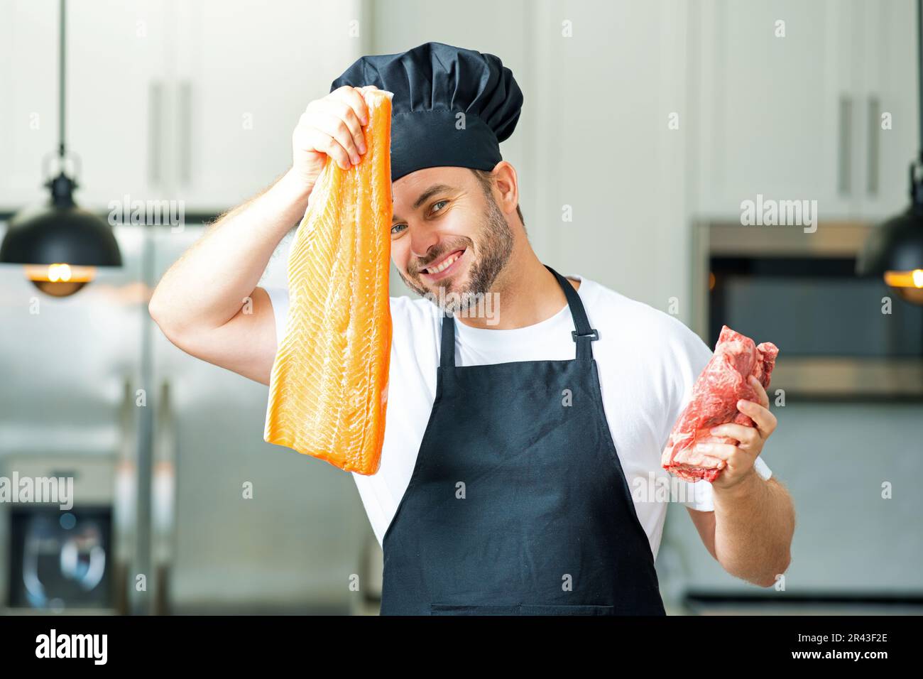 Man in modern kitchen, preparing healthy food alone, cooking fish and ...