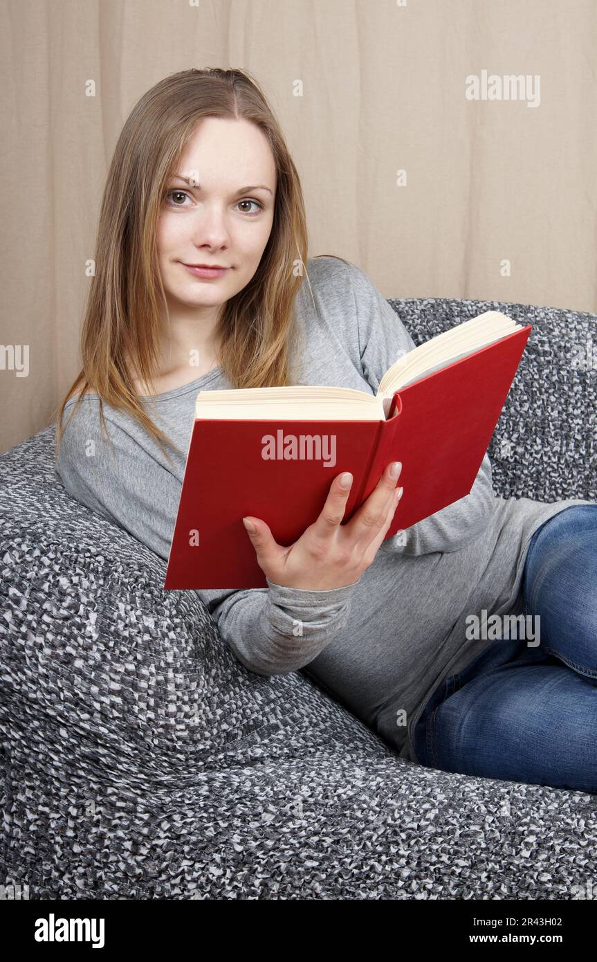 Young woman reading a book Stock Photo - Alamy
