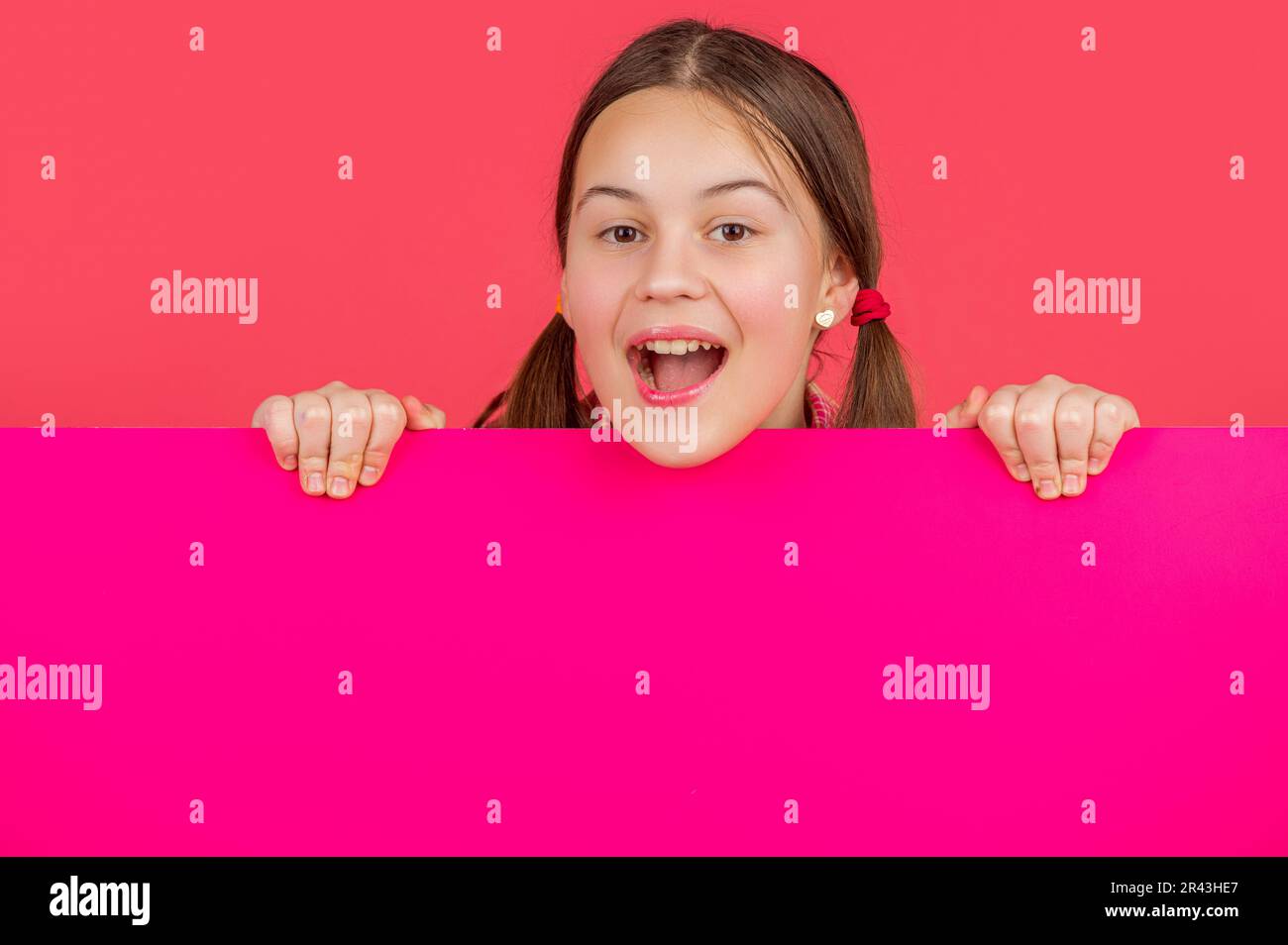 Amazed child behind blank hi-res stock photography and images - Alamy