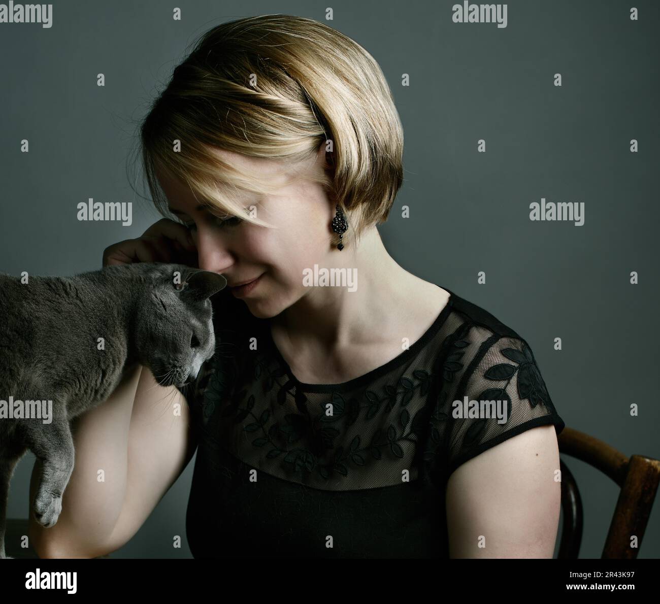 Portrait of a woman with her Russian Blue pedigree cat showing her affection Stock Photo