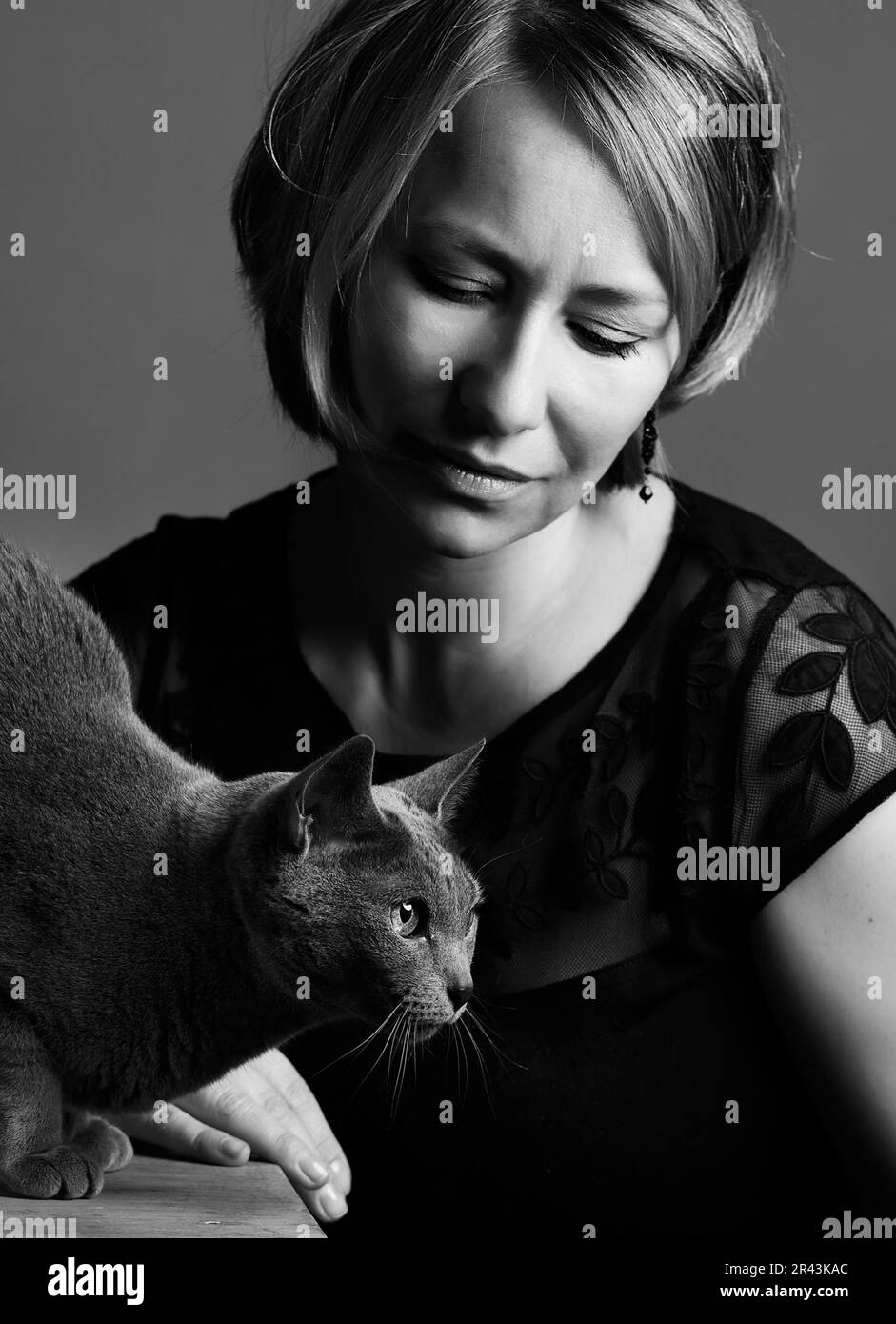 Portrait of a woman with her Russian Blue pedigree cat showing her affection Stock Photo