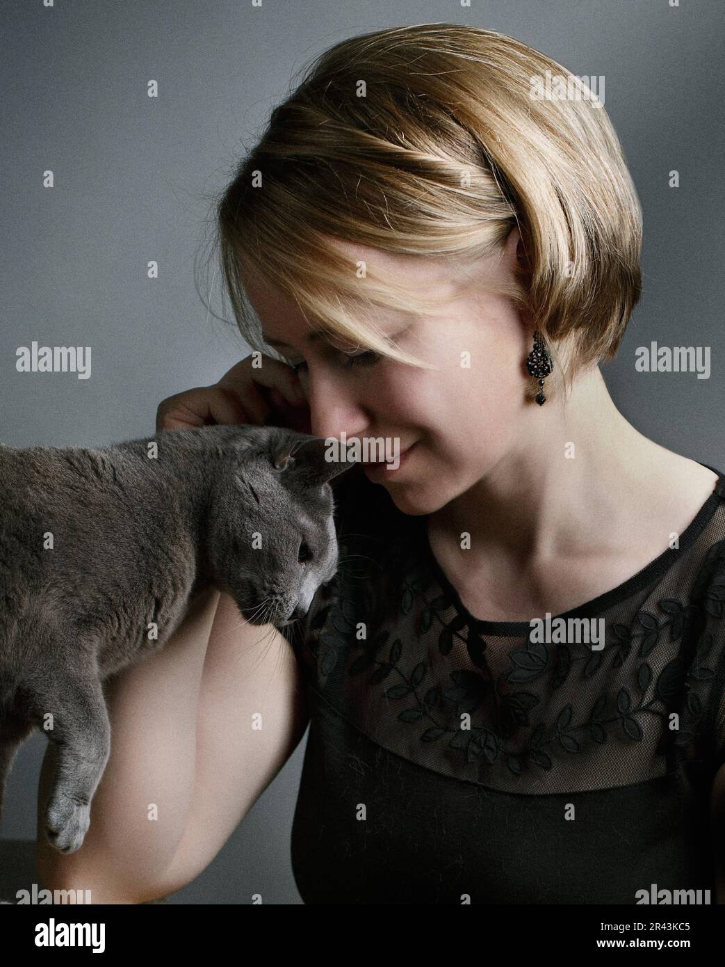 Portrait of a woman with her Russian Blue pedigree cat showing her affection Stock Photo