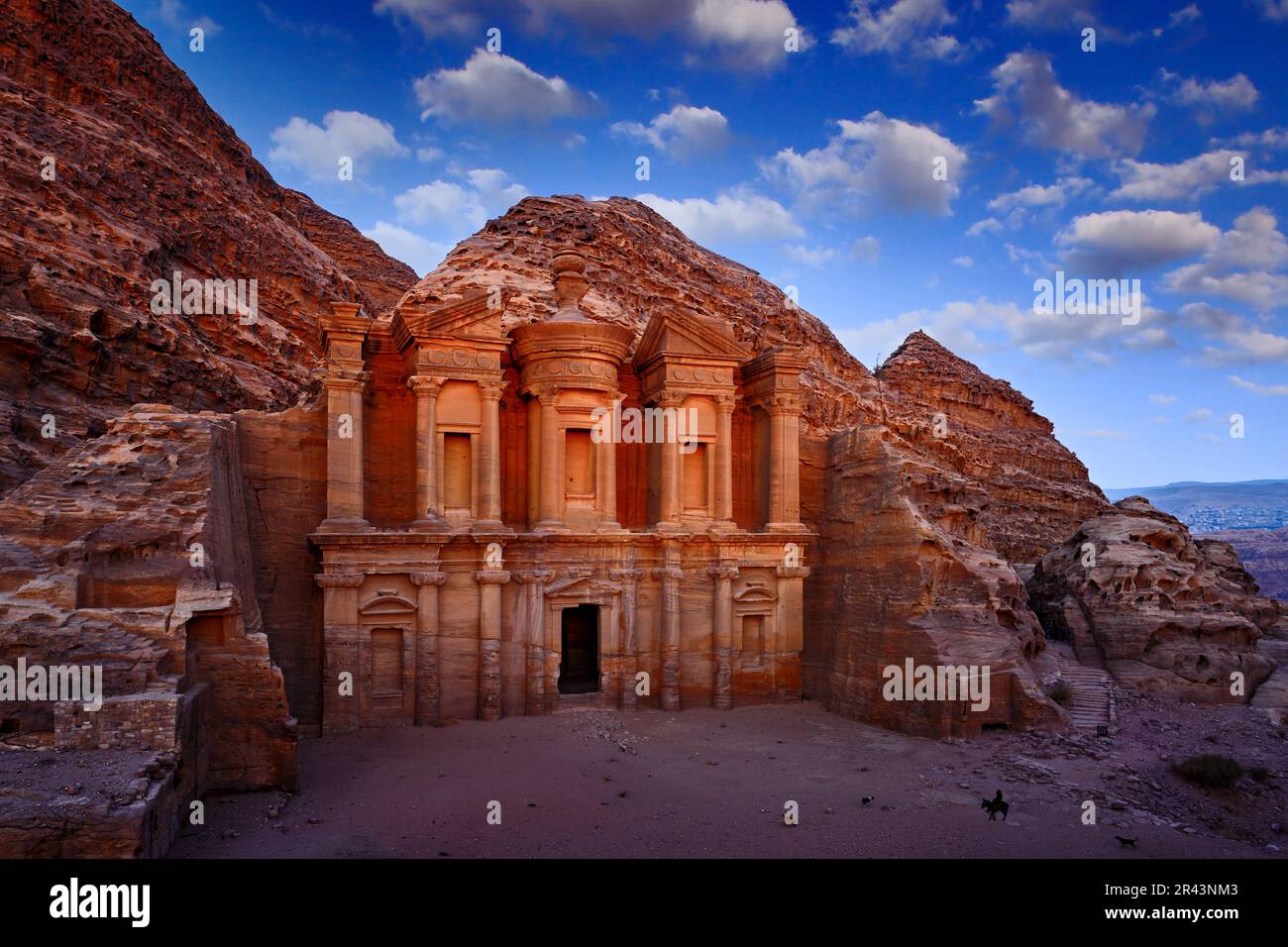 Travel in Jordan, Arabia in Asia. Stone Monastery in rock, Petra in Jordan. Red rock landcape. Petra historical sight - Ad Deir Monastery with blue sk Stock Photo