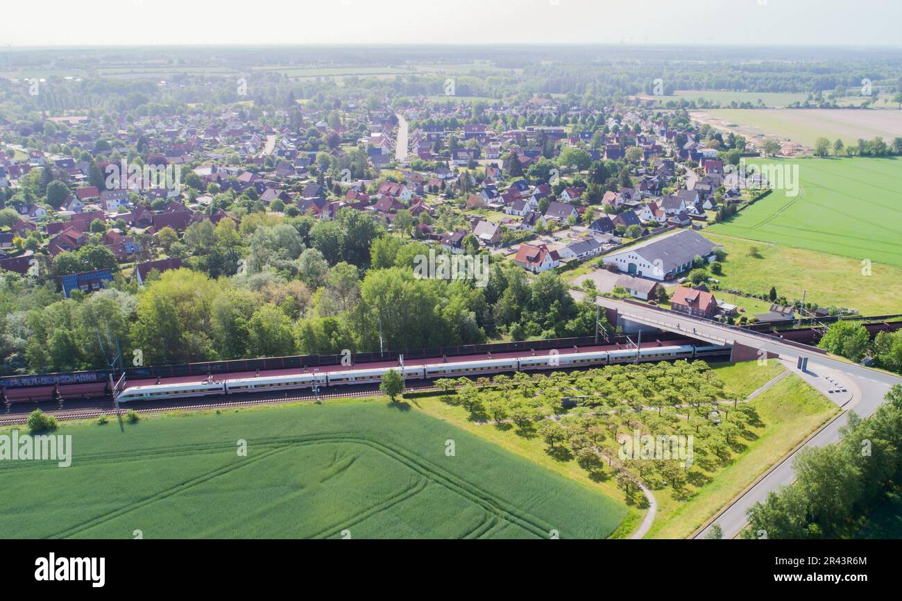 Eschede, Germany. 26th May, 2023. An ICE train passes the memorial for the victims of the Eschede ICE accident in the district of Celle. At 200 kilometers per hour, ICE 884 'Wilhelm Conrad Röntgen' crashed into a concrete bridge in Eschede on the morning of June 3, 1998. The worst rail accident in the history of the Federal Republic of Germany claimed the lives of 101 people. (to dpa-Korr 'Train accident in Eschede 25 years ago' of May 26, 2023) Credit: Julian Stratenschulte/dpa/Alamy Live News Stock Photo