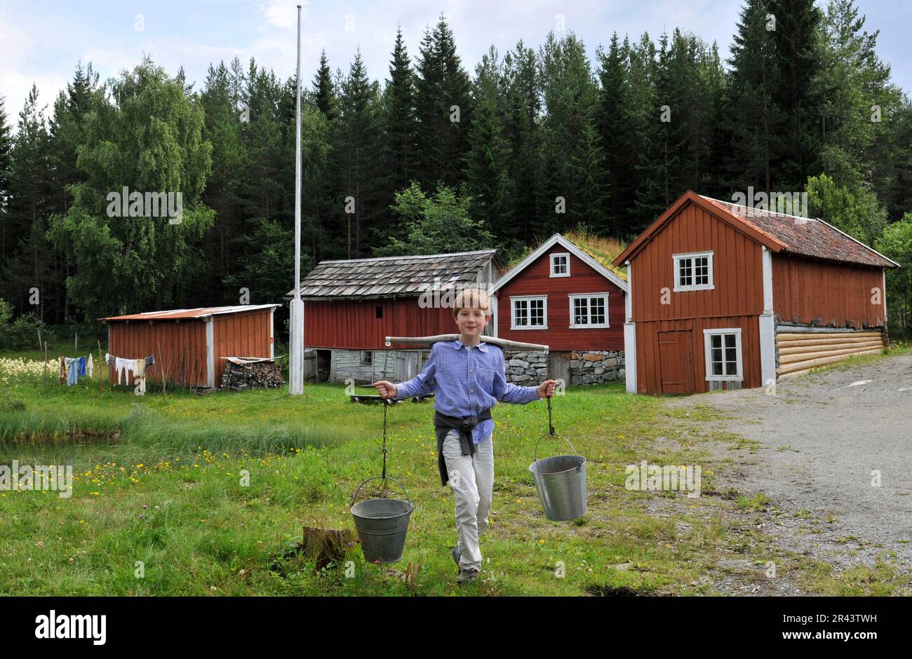 Boy, bucket, tin bucket, water bucket, carries water, water carrier