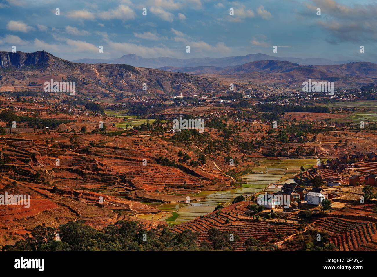 Madagascar landscape. mountain with fields and villages. Nature destruction in Africa, hot season in Madagascar. Orange fields with houses. Lookout vi Stock Photo