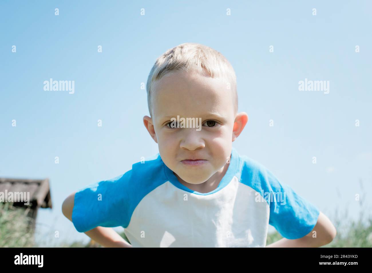portrait of a young blonde boy looking serious Stock Photo
