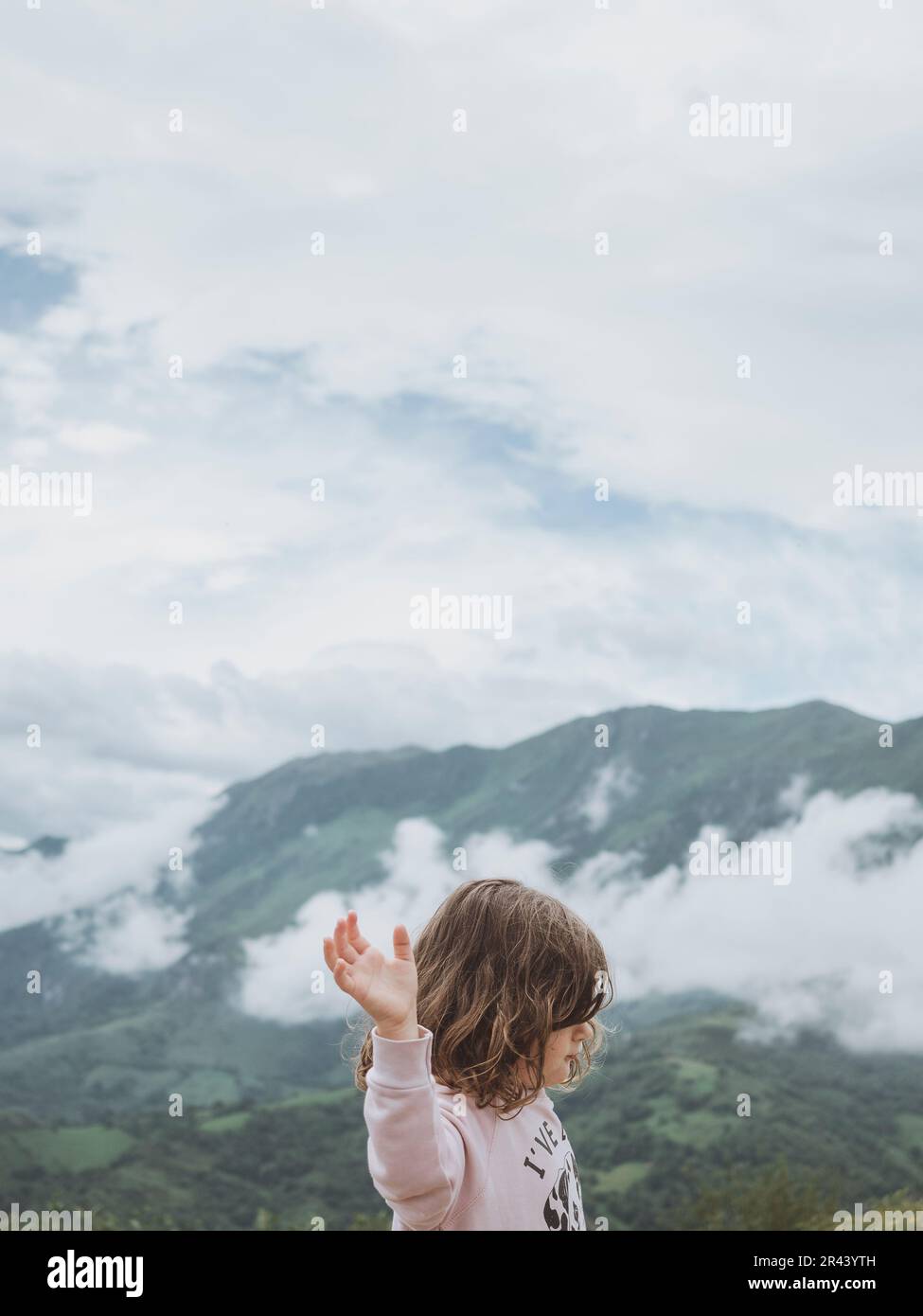 Little girl enjoying nature on the mountain Stock Photo