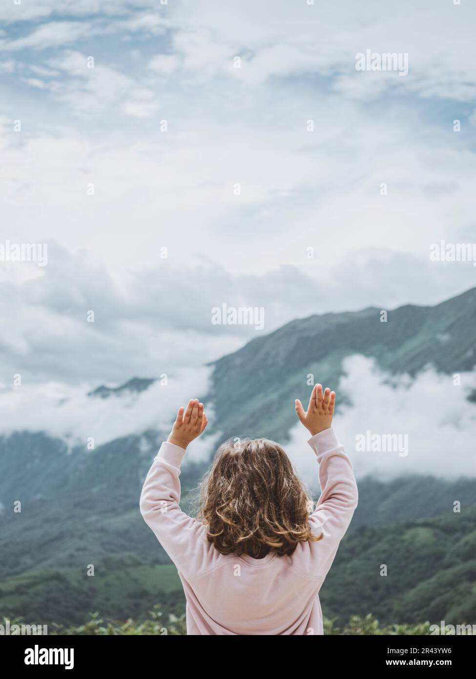 Little girl enjoying nature on the mountain Stock Photo