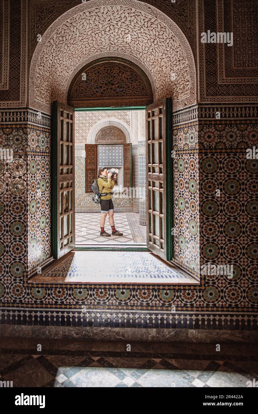 A female tourist takes a picture inside the casbah in Telouet, Morocco Stock Photo