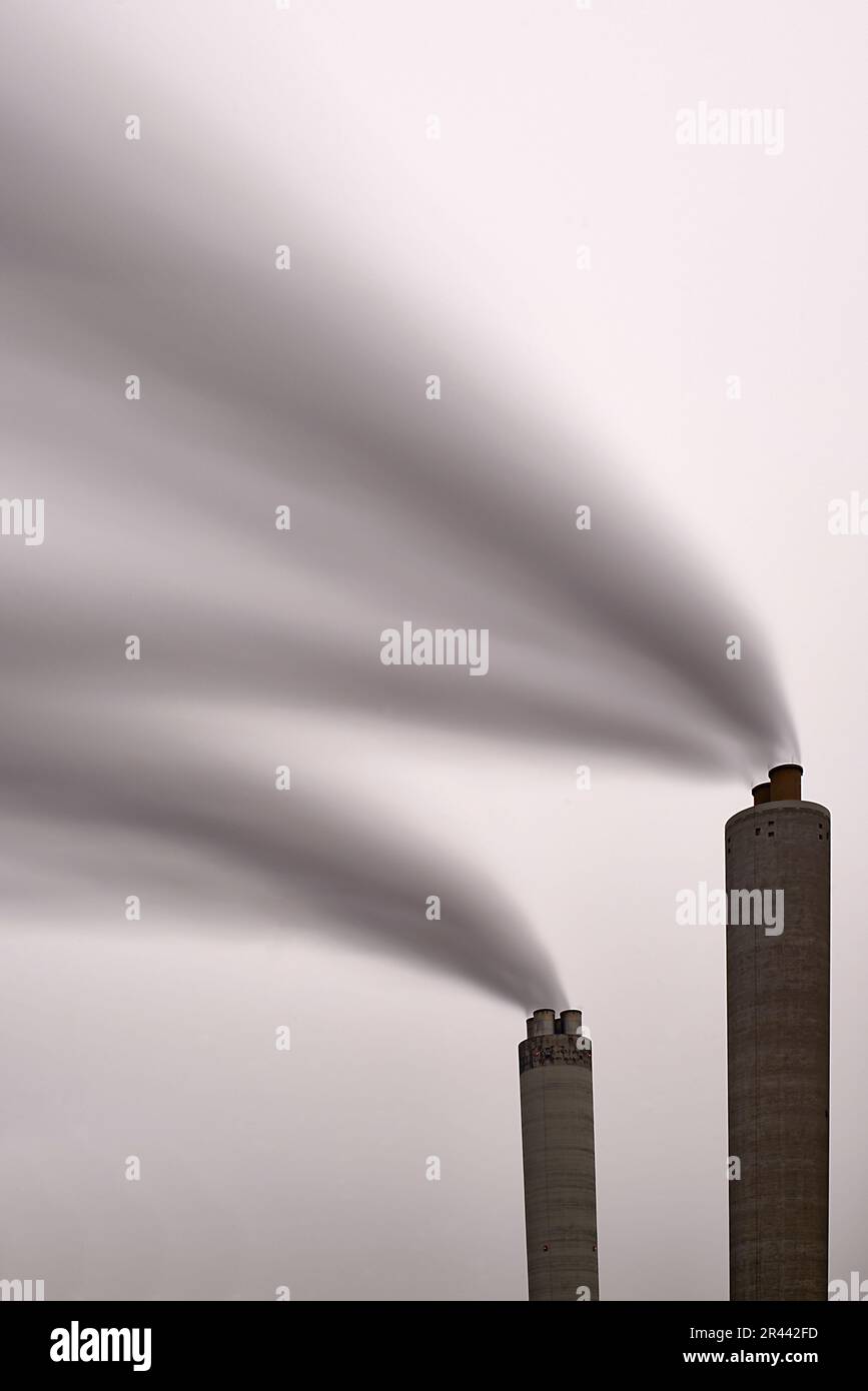 Long exposure of smoke coming out of a factory chimney Stock Photo