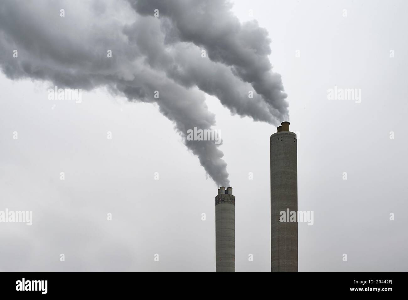 Long exposure of smoke coming out of a factory chimney Stock Photo