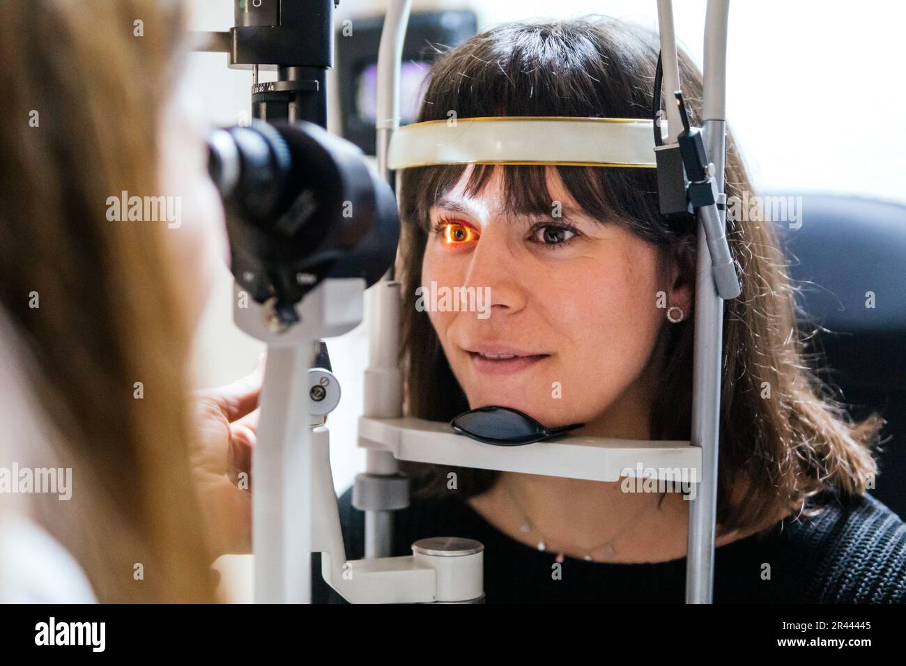 oculist looking at the eye with a machine to a patient Stock Photo
