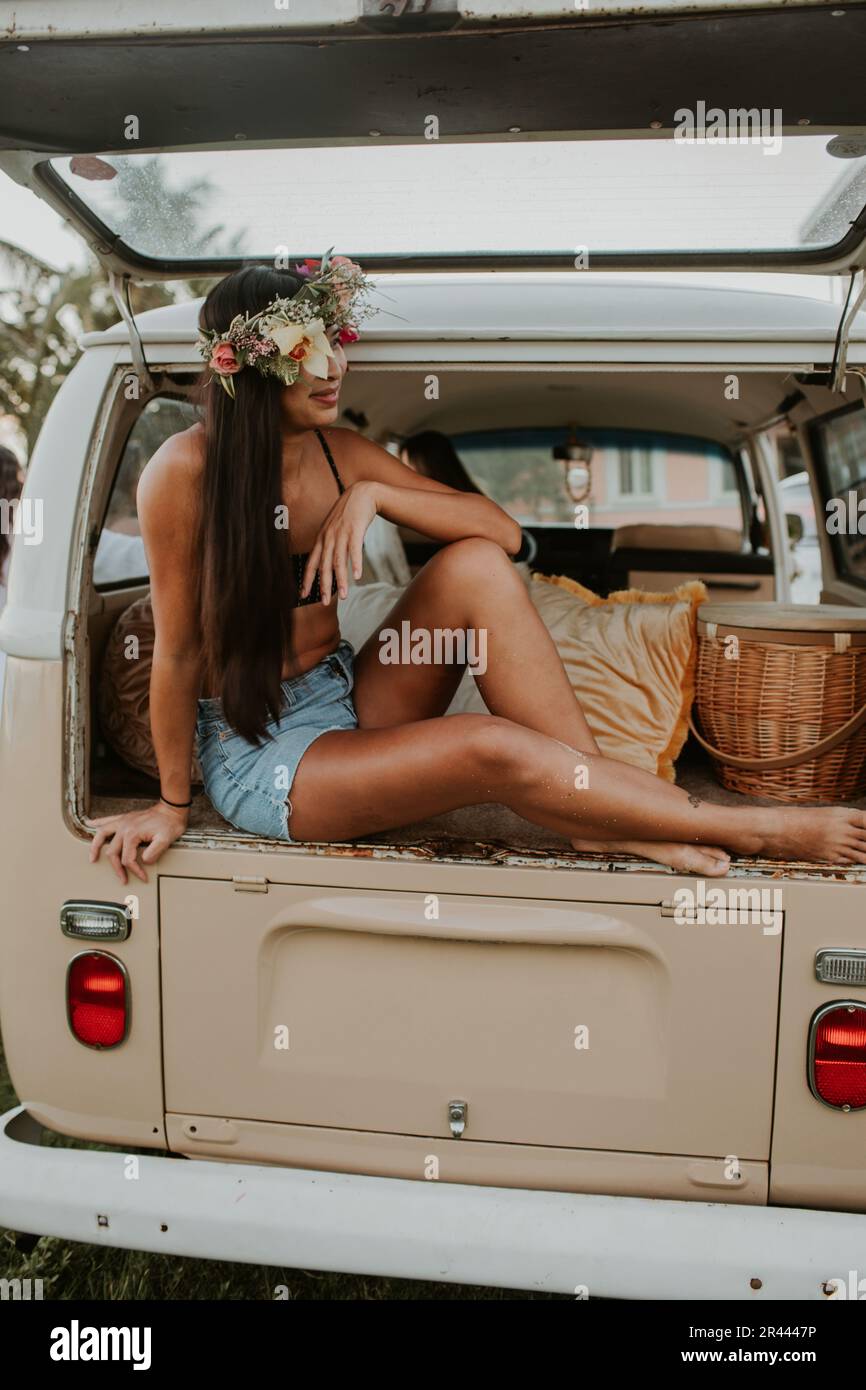 Happy, smiling Cambodian Asian woman wearing a lei in a van. Stock Photo
