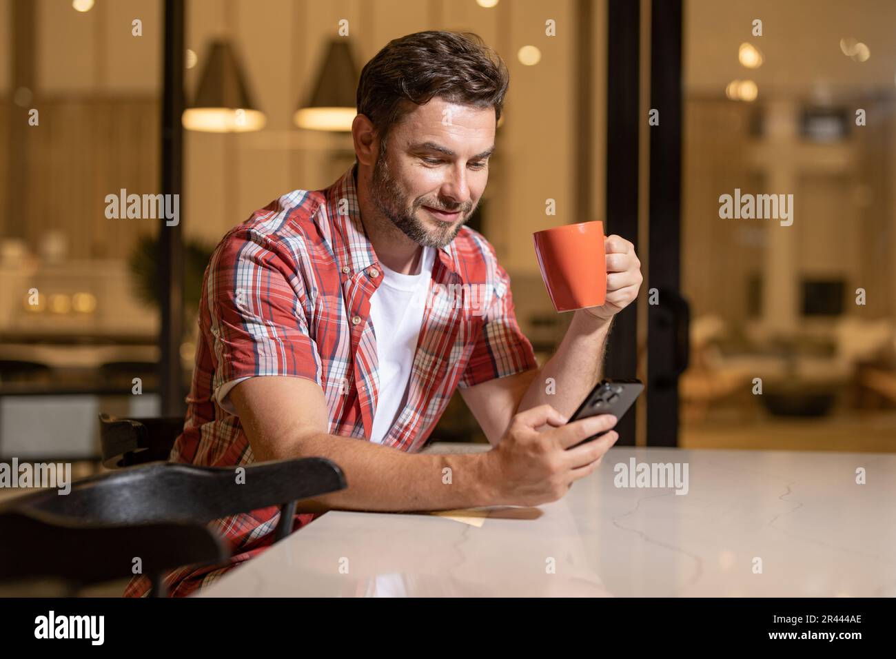 Male hipster using smartphone in concrete basement · Free Stock Photo