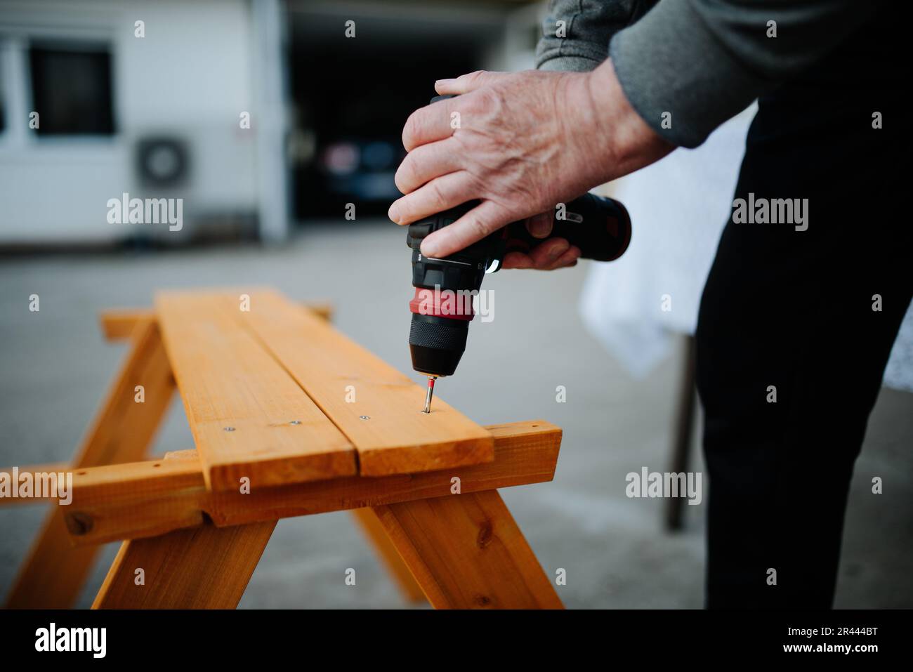 Carpenter using with wlectric drill closeup Stock Photo