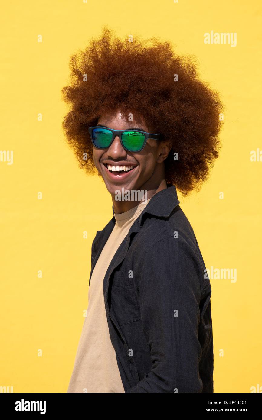 Side view of a isolated happy and satisfied young man with curly hair Stock Photo