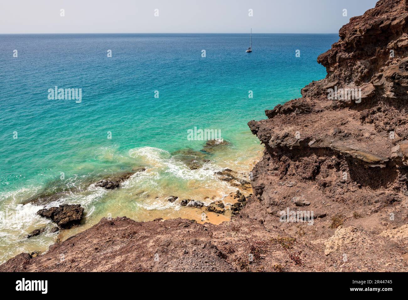 Rocks and sea. Rocky coast with the turquoise waters of the Atlantic Ocean. Fuerteventura, Canary Islands, Spain. Stock Photo