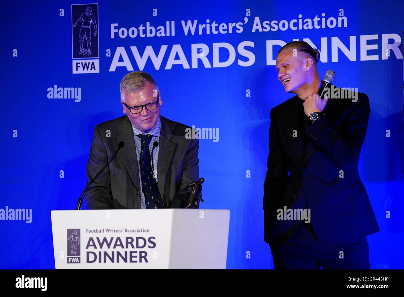Erling Haaland with his FWA footballer of the year trophy after receiving his award from John Cross, chair of the FWA during the FWA Footballer of the Year awards held at the Landmark Hotel, London. Picture date: Thursday May 25, 2023. Stock Photo
