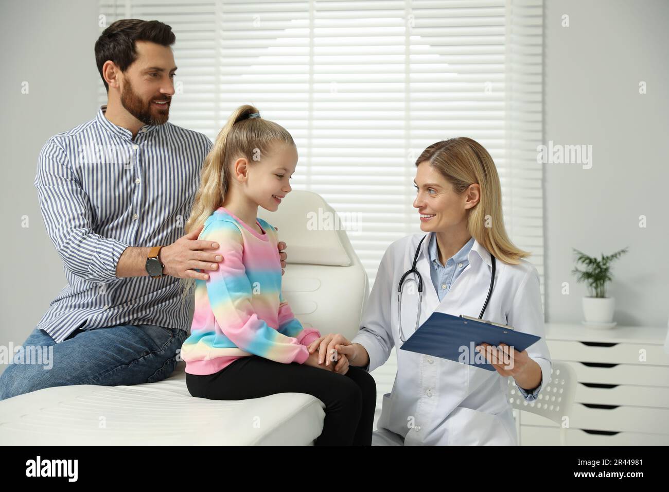 Father and daughter having appointment with doctor. Pediatrician