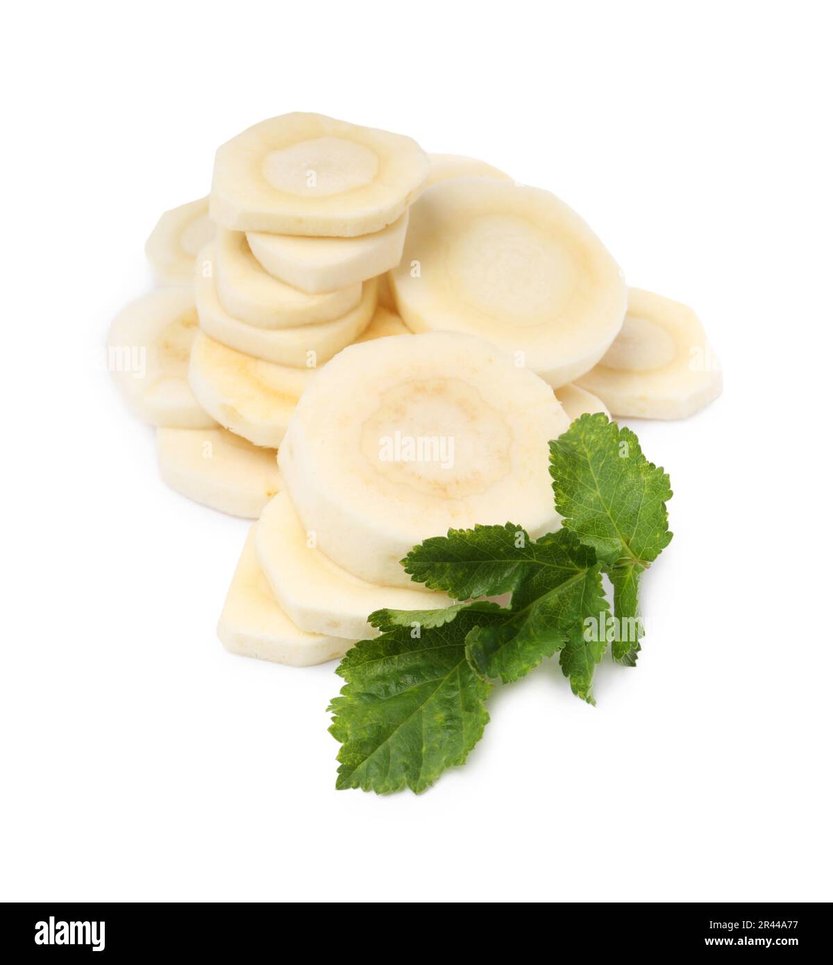 Cut fresh ripe parsnip with leaves on white background Stock Photo