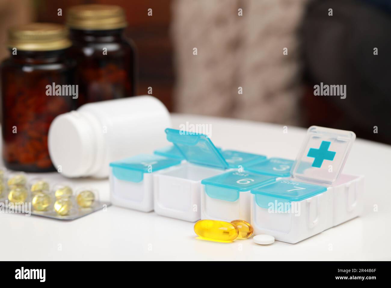 Plastic pill box with different medicaments on table Stock Photo - Alamy