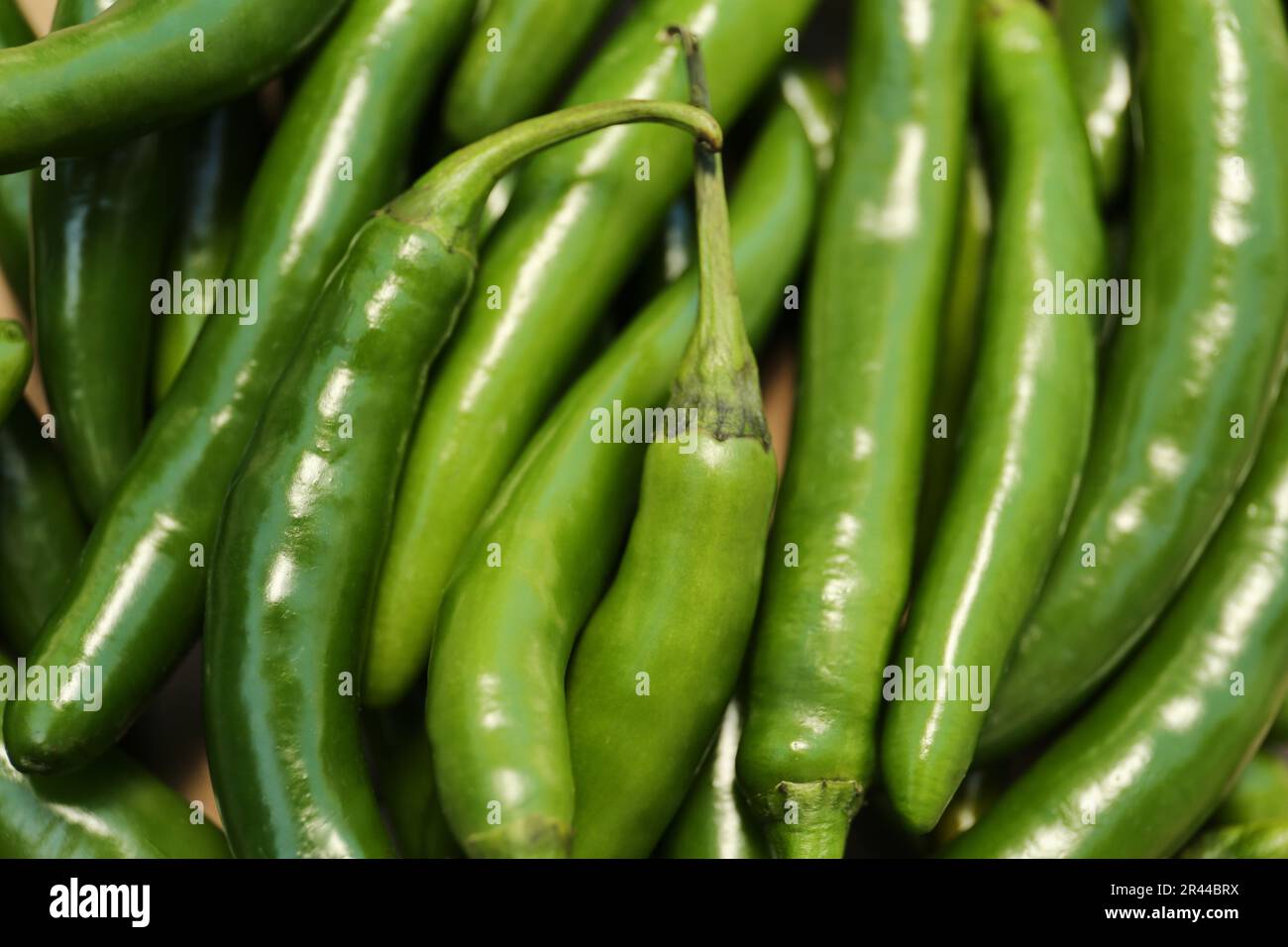 Green hot chili peppers as background, closeup Stock Photo - Alamy