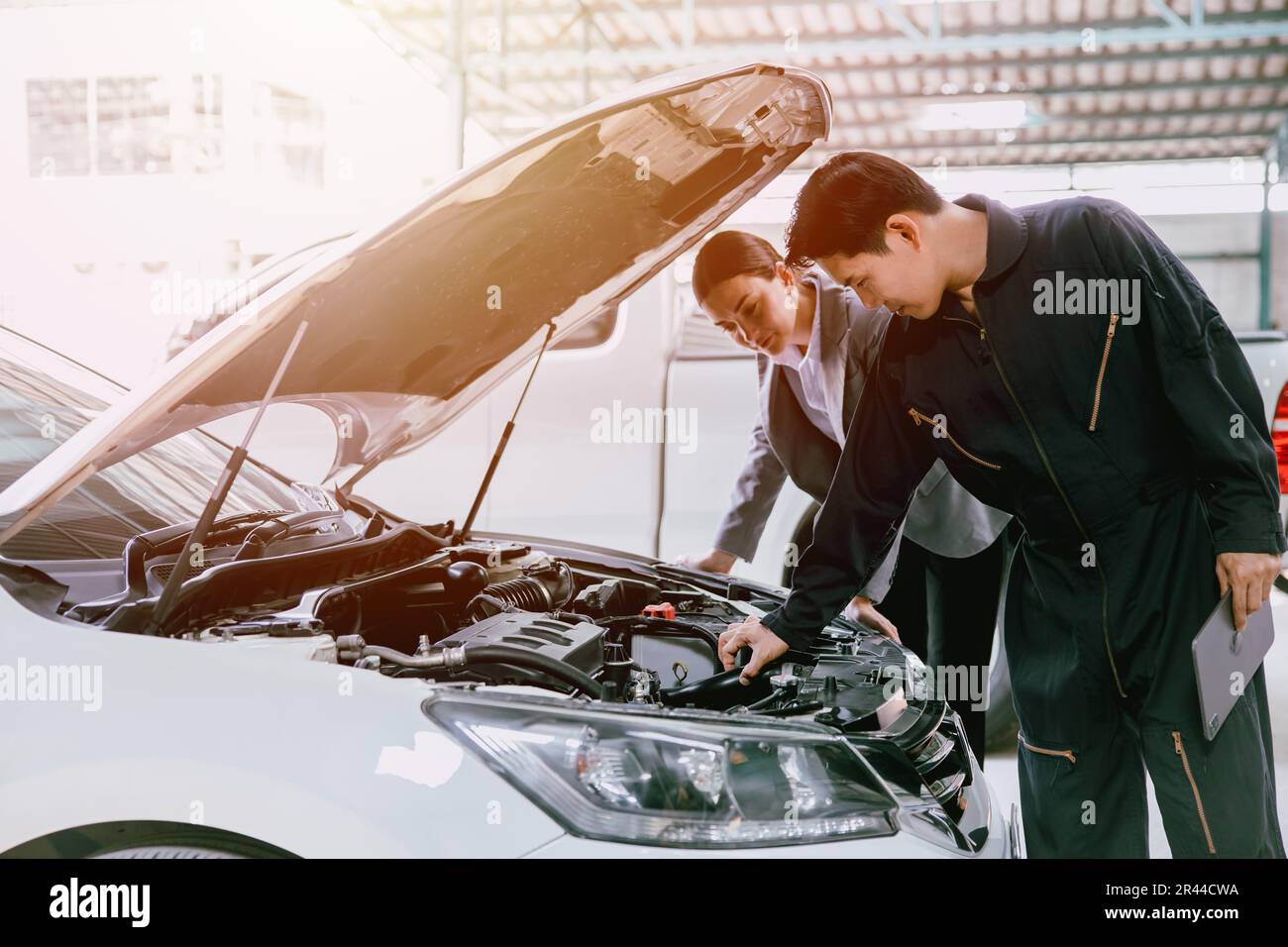 mechanic engineer working checking engine in garage auto shop car insurance claim cost estimate team Stock Photo