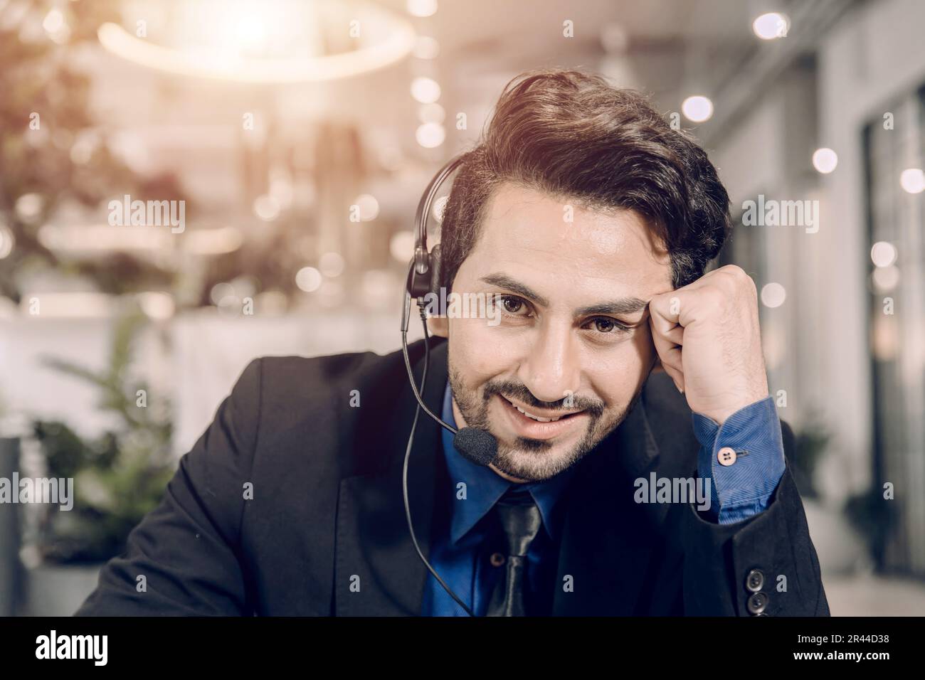 Portrait call center hispanic latin male business service support helpdesk call line happy smiling. Stock Photo