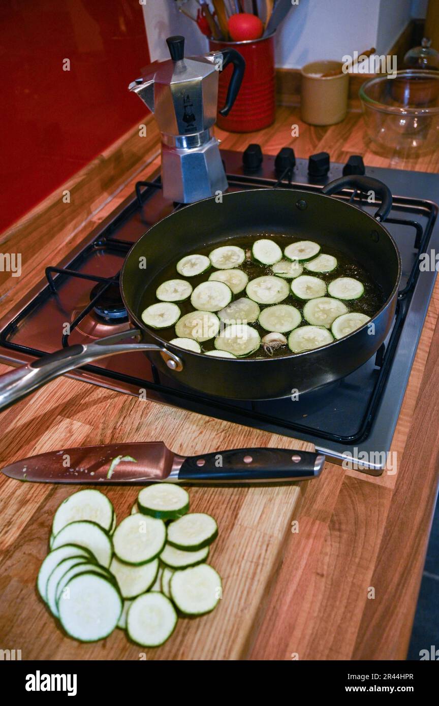 Frying off or browning slices of courgette or zucchini in sunflower oil