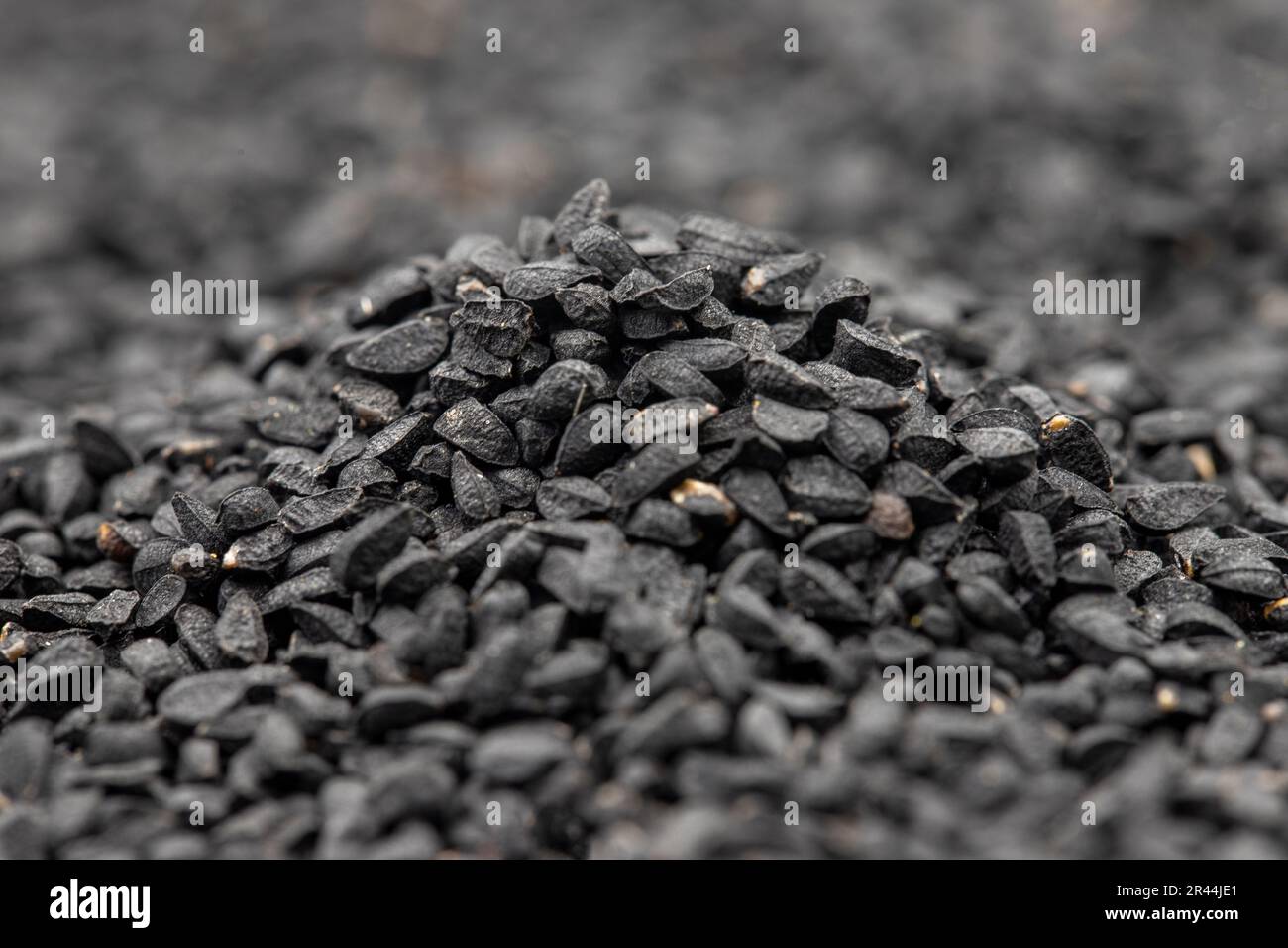 Pile of black cumin as background, spice or seasoning as background. Kalonji, nigella sativa, black cumin. Close up Stock Photo
