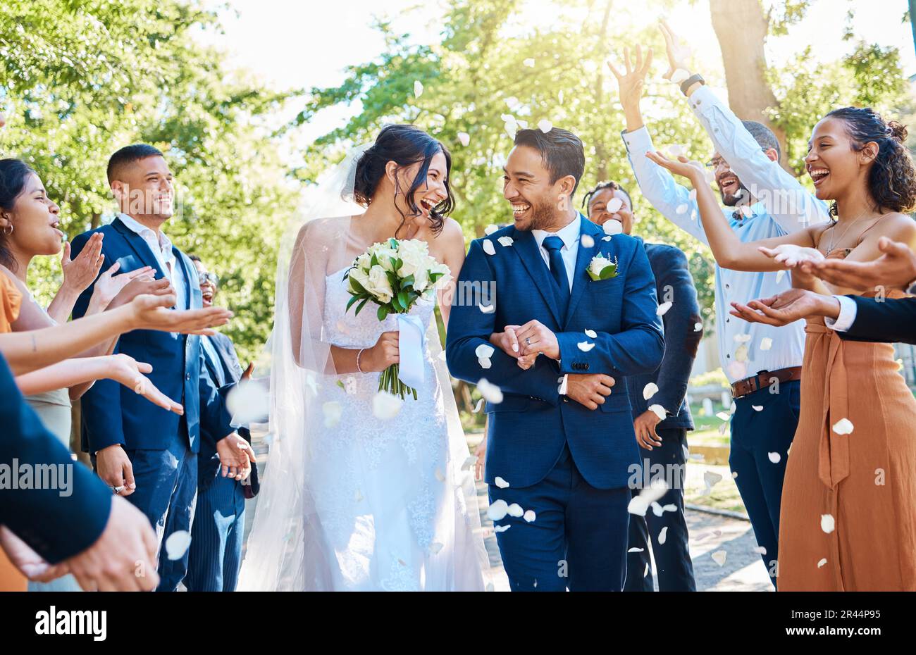 Happy, wedding ceremony and couple walking with petals and guests throw