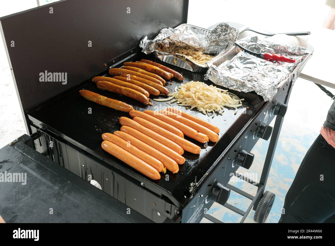 A traditional australian bbq sausage sizzle, sausages cooking on a