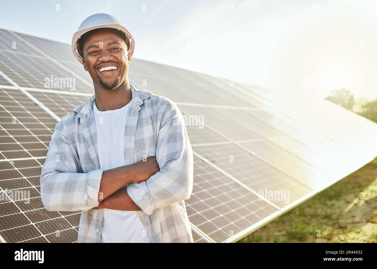 Man, engineer and solar panel on a farm for renewable energy, sustainability and eco environment. Portrait of a black male electrician happy about Stock Photo