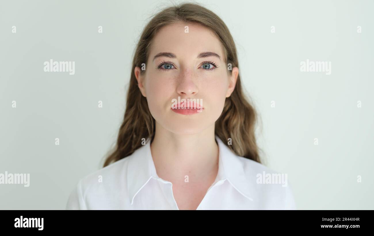 Portrait of young beautiful woman in white shirt Stock Photo - Alamy