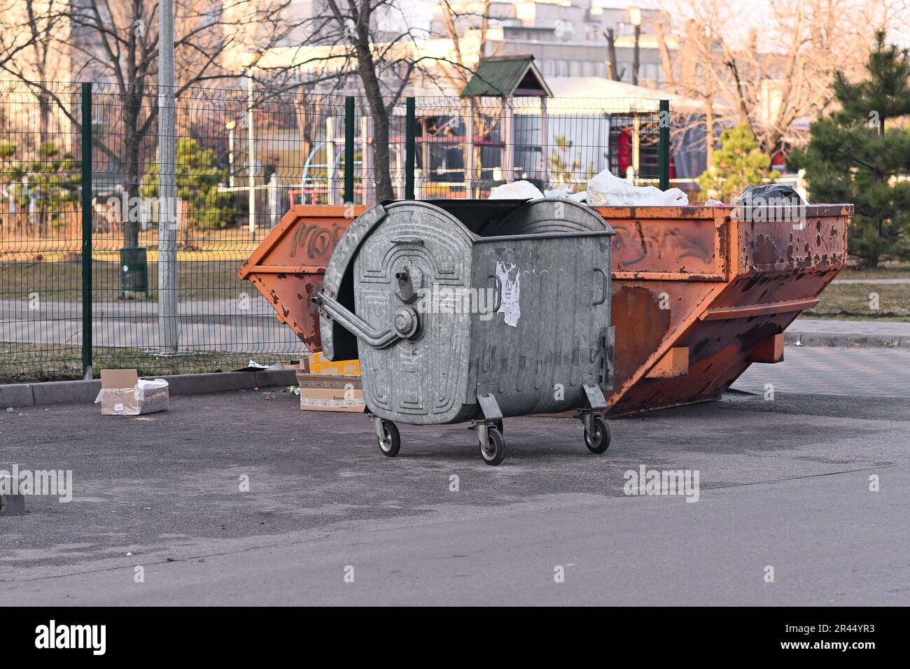 Two metal garbage cans. unsorted garbage. Unsorted garbage. in city yard Stock Photo